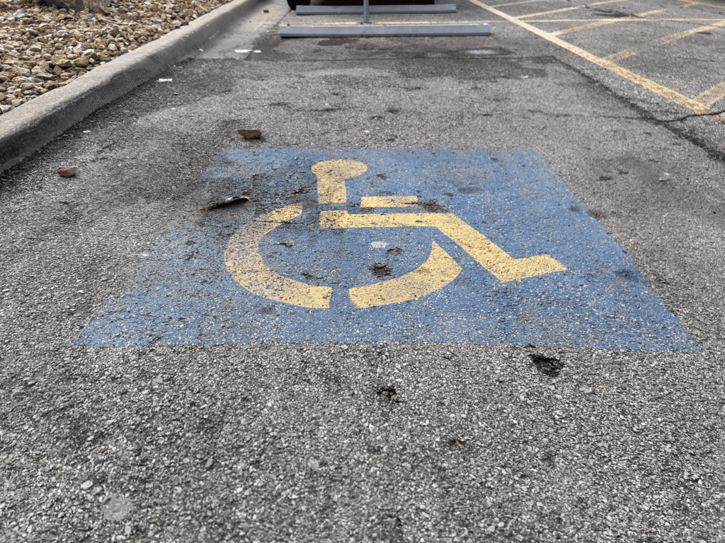 This is a dated handicap sign that needs to be re-striped. This is a commercial retail center in Overland Park on Metcalf Avenue in 66212